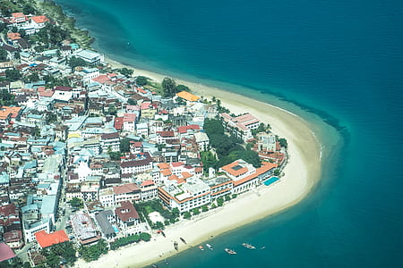 bird's-eye view photography of houses near ocean thumbnail
