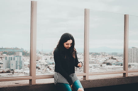 woman sitting on brown surface thumbnail