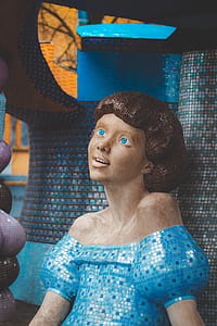 statue of smiling woman in blue off-shoulder top thumbnail