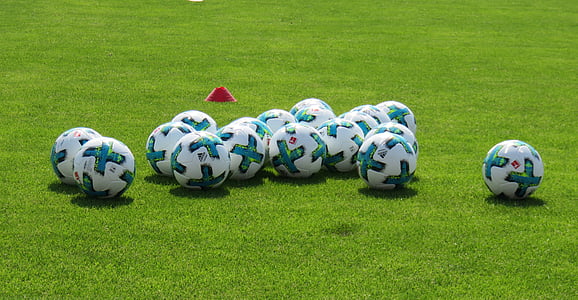 white-and-green soccer balls on field thumbnail