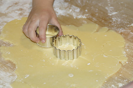 two gray cookie cutters on dough thumbnail