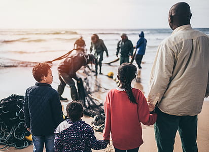 people gathering on seashore during daytime thumbnail