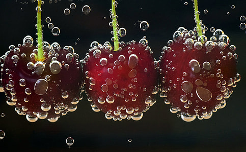 three red cherries dipped on carbonated water thumbnail