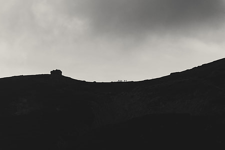 silhouette of mountain under nimbus clouds thumbnail