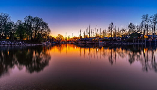 reflection landscape photography of houses near body of water thumbnail