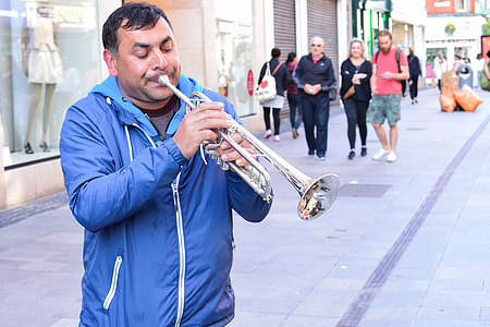 man playing trumpet during daytime thumbnail