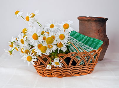 white petaled flower with basket beside clay vase thumbnail