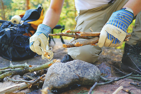 person setting firewood on ground thumbnail