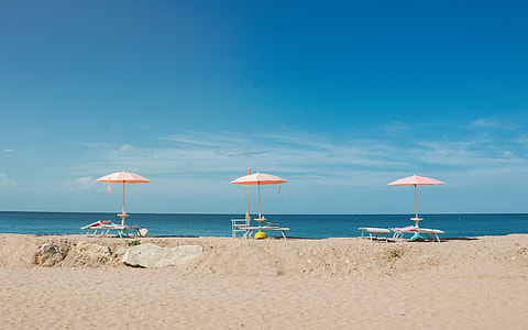 three pink-and-white beach parasols thumbnail