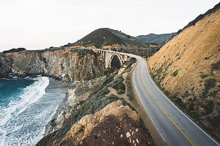 aerial photography of mountain hill and ocean shore view during daytime thumbnail