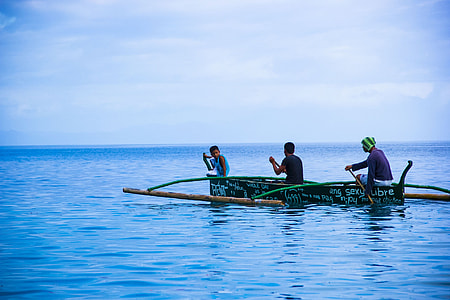 three man on boat in the middle on calm blue sea under blue sky thumbnail