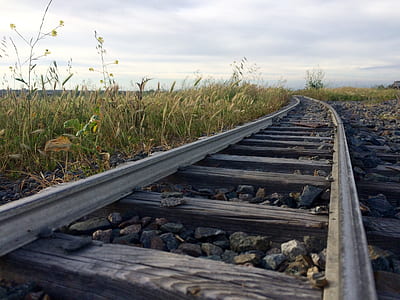 selective focus photography of train rail thumbnail