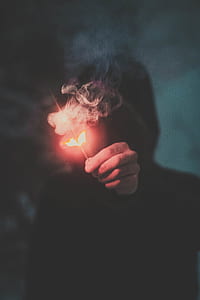 person wearing hoodie holding firecracker thumbnail