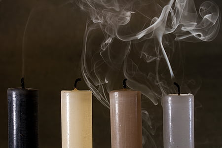 four assorted-color lighted out candles thumbnail