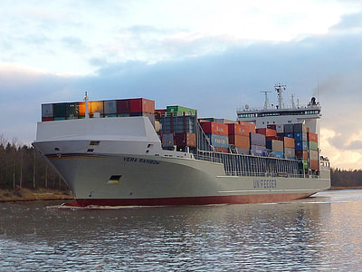 cargo ship with container loaded and surrounded by body of water thumbnail