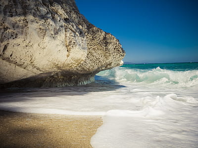 photography of cliff beside beachline thumbnail