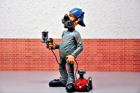 man holding spray gun and canister thumbnail