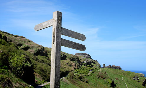 road signage near mountain during daytime thumbnail