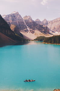 three person riding on canoe during daytime thumbnail