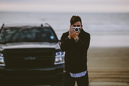 man holding camera thumbnail