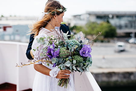 bride holding purple flowers thumbnail