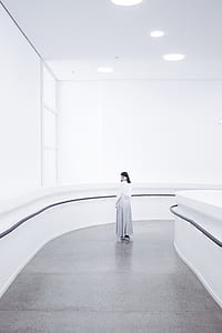 grayscale photo of woman standing on pathway thumbnail