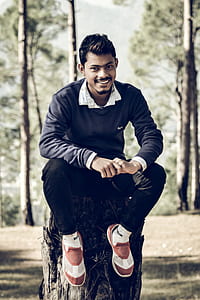 Person Sitting on Tree Trunk thumbnail