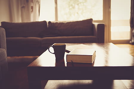 black ceramic mug on brown wooden coffee table thumbnail