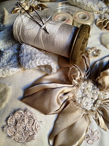 white sewing thread on floral textile thumbnail