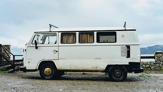 white Volkswagen van parked near wooden fence at daytime thumbnail