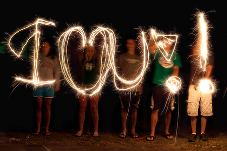 group of person doing i love you time lapse light photography thumbnail
