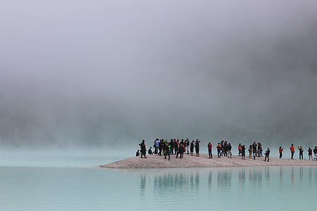 people standing on gray surface on body of water photography thumbnail