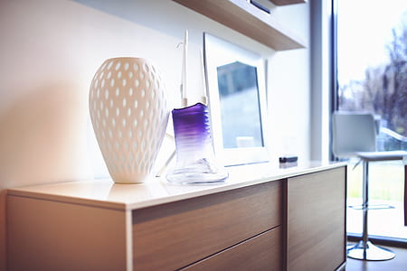 white vase on top of brown wooden dresser thumbnail