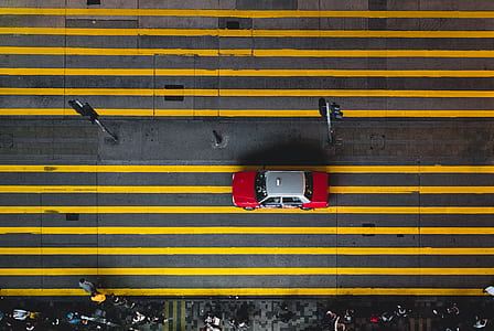 tilt-shift photo of taxi cab on road near people thumbnail