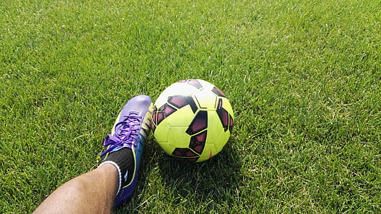 person wearing cleat shoe beside soccer ball thumbnail
