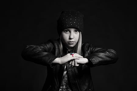 grayscale photography of a woman wearing leather jacket thumbnail