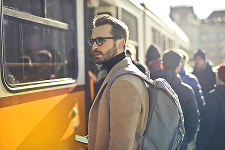 Handsome bearded male backpacker with backpack on his shoulders,waiting at the tram station thumbnail