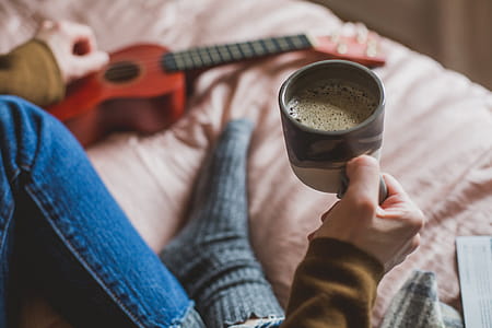 Holding Coffee In Bed Photo thumbnail