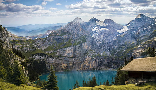 structural shot of mountain near body of water under cloudy weather thumbnail