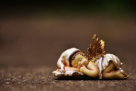 macro photography of baby angel ceramic figurine thumbnail