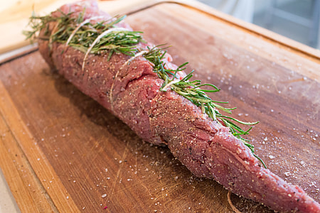 preparing meat with rosemary, salt and pepper thumbnail
