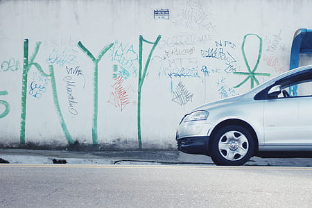 silver car beside white wall thumbnail