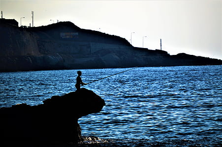 person fishing on cliff thumbnail