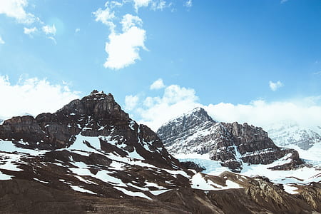 snow covered mountains under sunny sky thumbnail