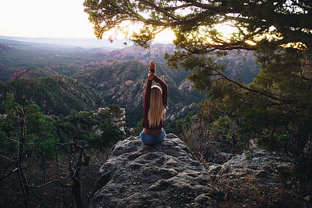 woman sitting on edge of cliff mountain thumbnail