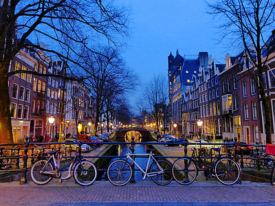 three bicycle parked near canal in Amsterdam thumbnail