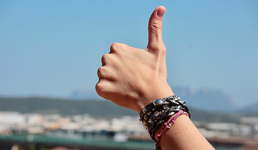 person's left hand doing thumb's up signage thumbnail