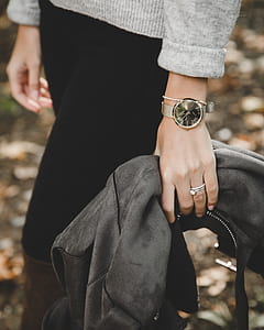 Person Wearing Gray Knit Sweater Holding Black Leather Jacket thumbnail