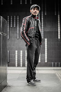 man standing near black wall tiles thumbnail
