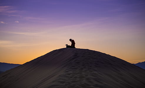 person kneeling on desert thumbnail
